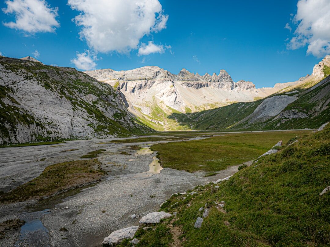 Scenic hiking trail through green alpine meadows in Switzerland