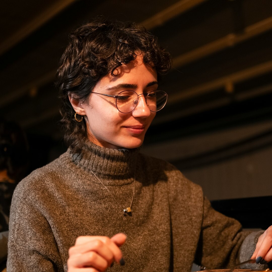 Studio portrait of a young swiss female writer with glasses
